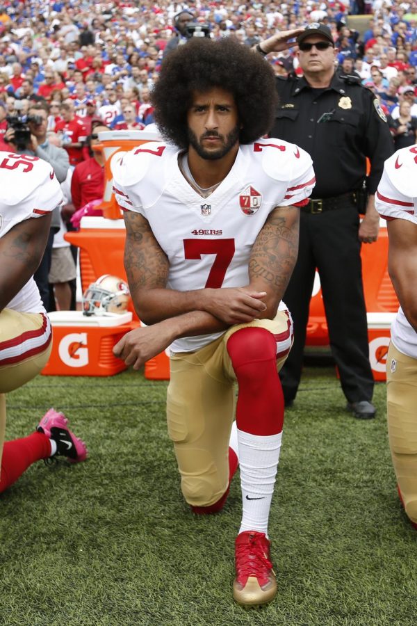 Kaepernick takes a knee during the anthem.